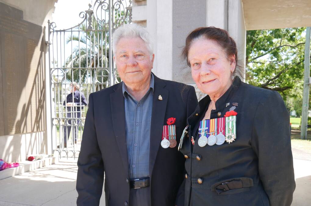 AN ODE TO ALL: Serviceman Brian Cairns and Marion Brunning, whose late husband served in the Vietnam War. They stand in front of the memorial gates on Carp Street beside wreaths laid in remembrance. Photo: Ellouise Bailey