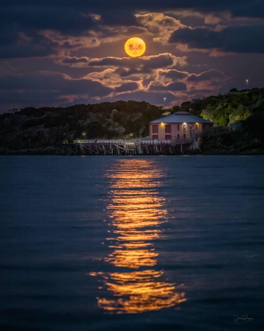 The supermoon rose above Tathra Wharf in July 2021 and photographer David Rogers was at the ready to capture this incredible scene. Photo: David Rogers