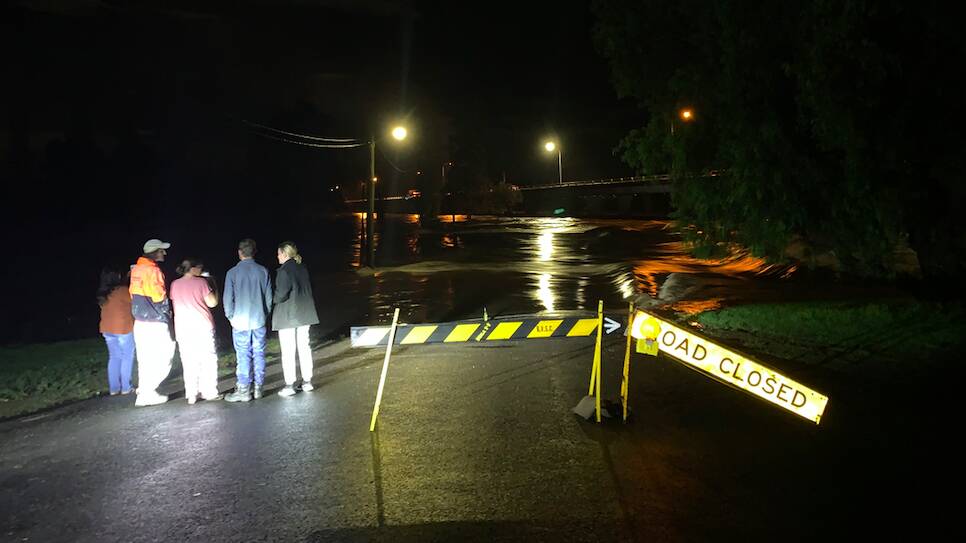 Bega residents crowd at the end of Valley Street to watch the rising flood waters around 10.00pm March 23. Photos by Ellouise Bailey. 