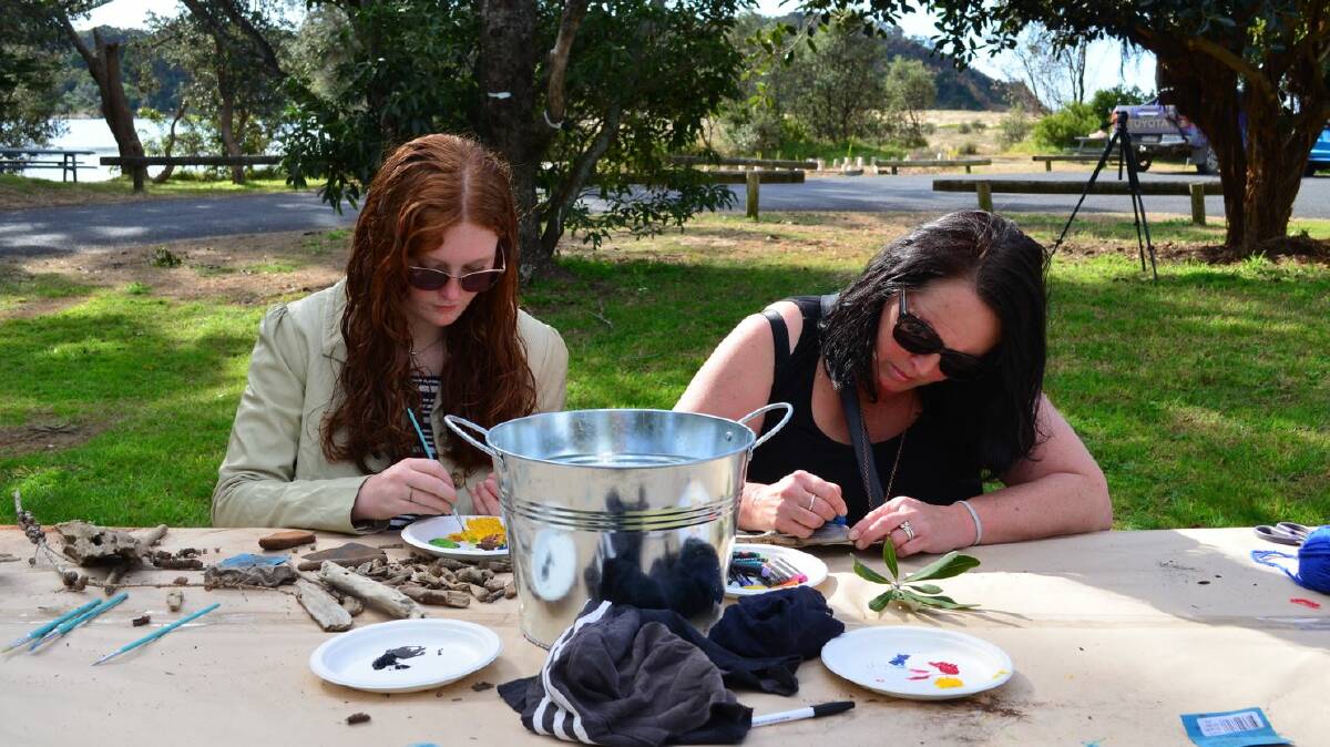 Members of the Tathra community engaging in a community workshop held in Tathra on 18 July with a focus on creating artwork using driftwood. Picture supplied