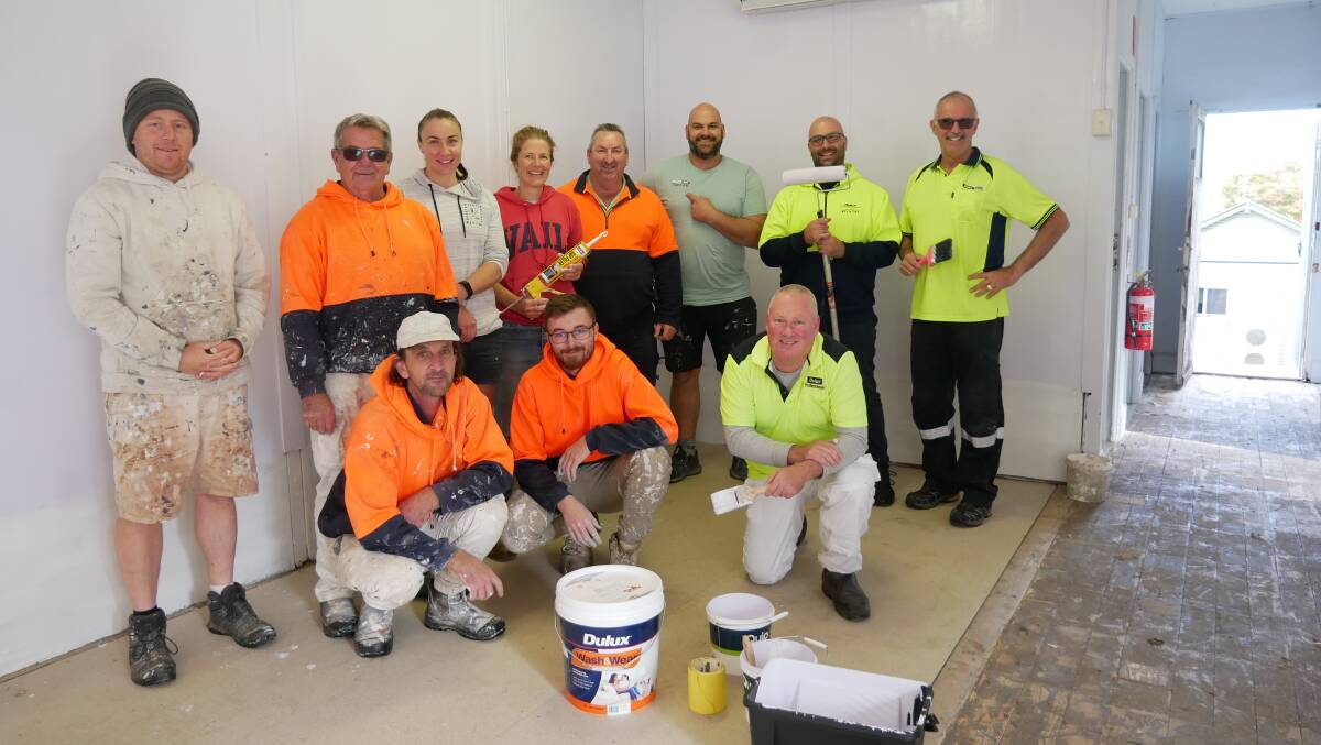 A group of volunteers who came to help paint the Bega Girls Guides Hall on Tuesday, May 31, include (back, from left) Jacob Muthsam, David Carpenter, secretary of the parent body Amanda Bastian, treasurer of the parent body Kate Ireland, John Watkin, Andoni Vatalis, Jonno De Angelis, Greg Scott, (front) Chris Smith, Connor Gould, and Leon Harrington. Photo: Ellouise Bailey
