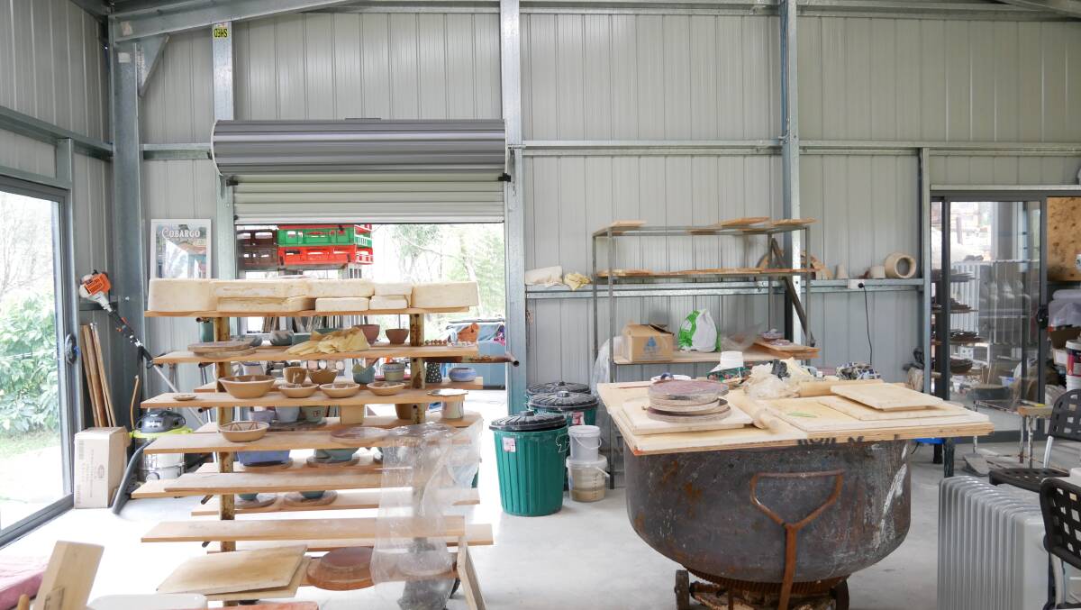 The inside of the studio where you can see the dough mixer which survived the fires and is now being used as a table base. 