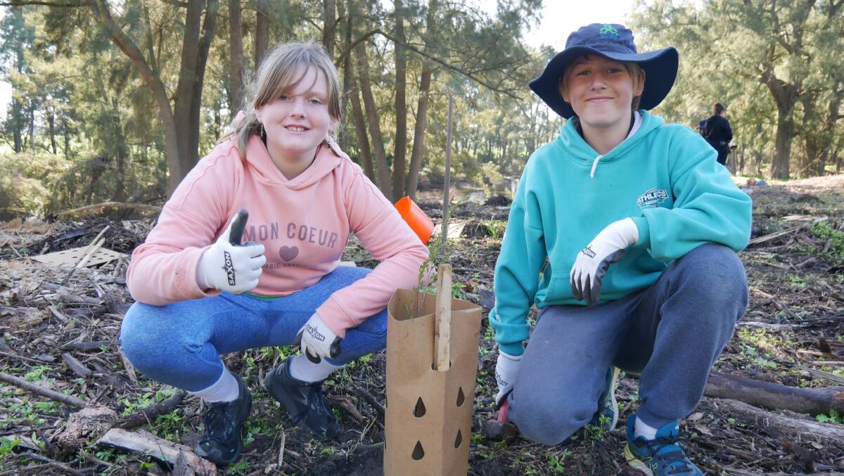 BVPS pupils Alisha and Phoenix proudly show off their tree-planting efforts. Picture: Ellouise Bailey