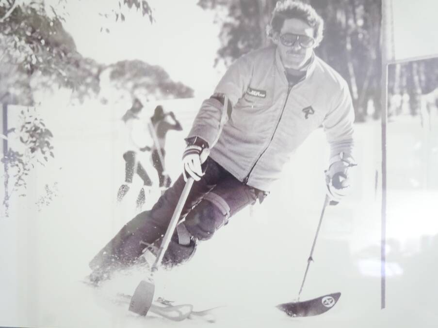 A younger Ron Finneran demonstrates some of the equipment he created to assist him down the mountain, including outriggers on his arms and a knee brace on his legs. Photo: supplied