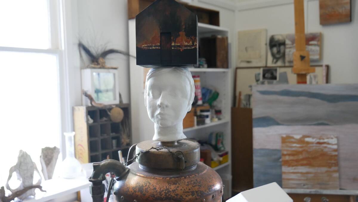 Karyn Thompson's sculpture titled Fire Fight - Self Portrait as a Fire Extinguisher. The piece features an airdried clay model of her head with a small plywood version of her house to represent the idea of 'having the house of her mind'. The head is fused onto an antique fire extinguisher. Picture: Ellouise Bailey 