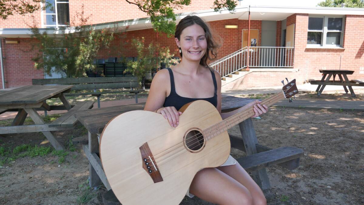 Industrial design timber products and furniture technologies student, Scarlett Whitaker who created a beautiful timber bass guitar as for her HSC major work. Picture by Ellouise Bailey 