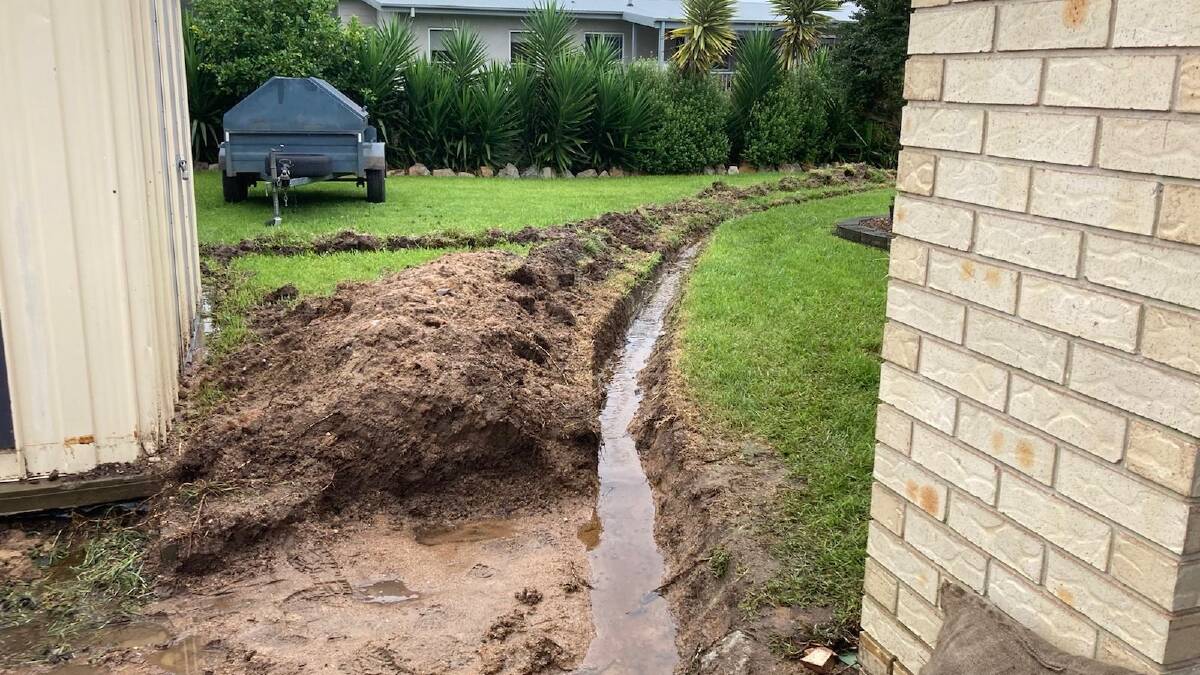 A Bega homeowner who had dug trenches around his house yesterday afternoon is preparation for flooding. Photo: supplied 