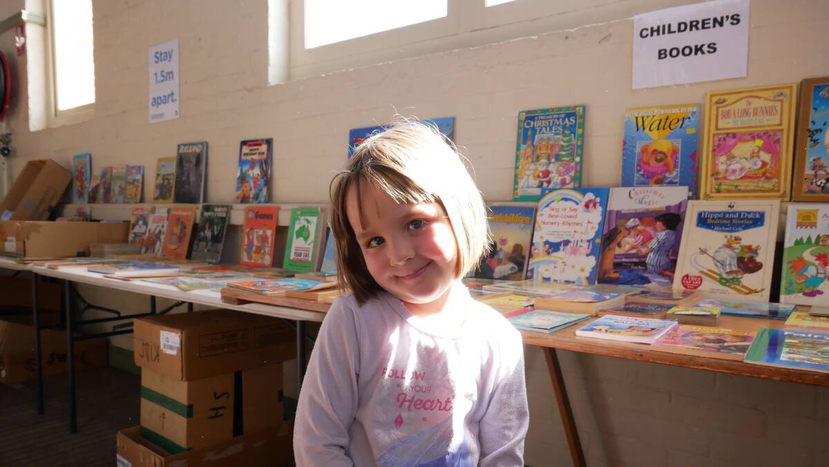 Harriette enjoying the children's section at the Rotary book fair. Photo: Ellouise Bailey