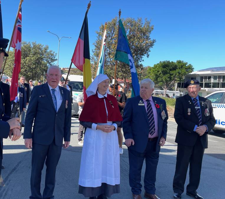 Barry Goodwin, Narooma RSL sub-branch secretary and Ricci Bishop, who was a registered nurse for more than 50 years, stand with Narooma RSL sub-branch president Paul Naylor and treasurer Jon King, before the march began. Picture by Marion Williams.
