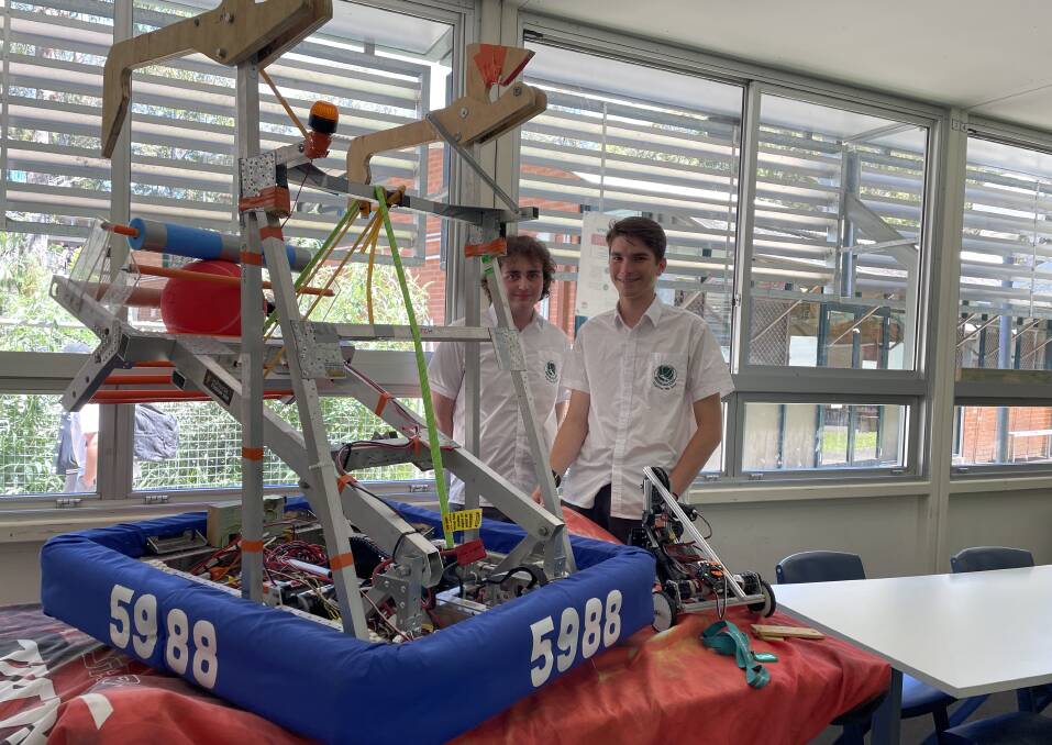 Lincoln McLeod-Scott and Harrison McKee with the team's entry for the FIRST Robotic Competition. Picture by Marion Williams
