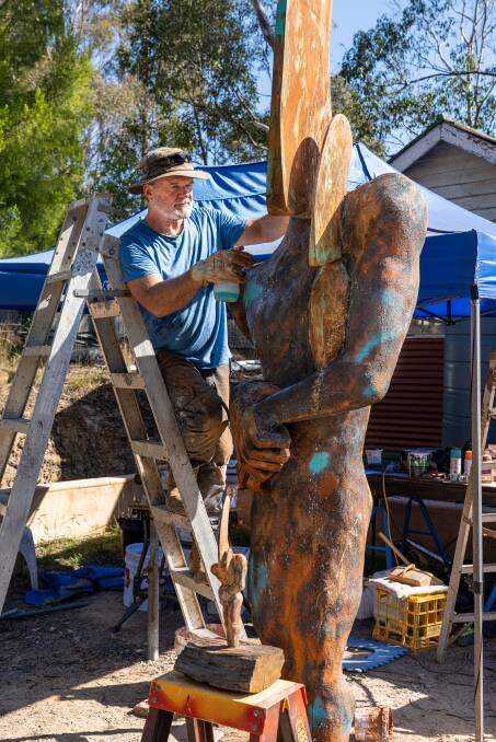 Ross Cameron working on his sculpture Father and Child which he is exhibiting at Sculpture Bermagui March 11 to March 19. Picture supplied.