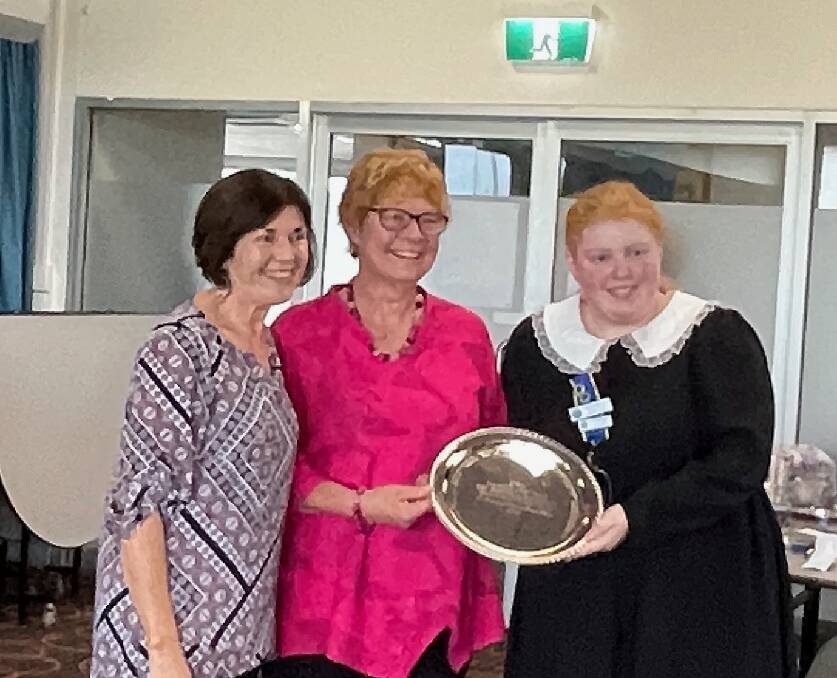 Sharron Perry, FSCG handicraft officer, gives the championship to Sally James from Narooma branch and Cassandra Cole from Cobargo branch. Picture by Marion Williams