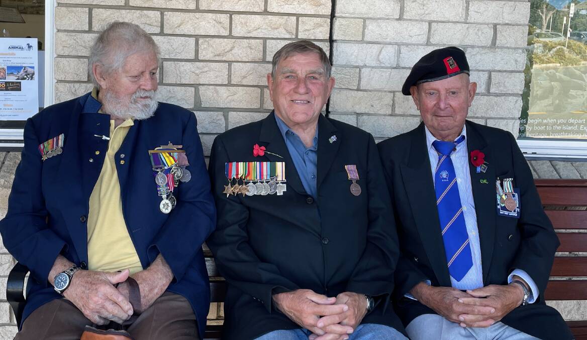 Veterans Lyn Orford (Bodalla), Terry Tillam (Narooma) with his medals and those of his father Ken, and Tony Gors (Narooma) waiting for the Anzac Day 2023 march to begin in Narooma. Picture by Marion Williams