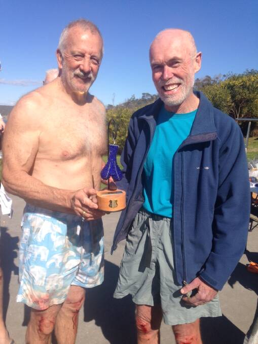 Bermagui Blue Balls founder Gary Pearse hands over the Vim Hof Trophy to the 2016 BBB Club Person of the Year, Robert Johnson. File picture