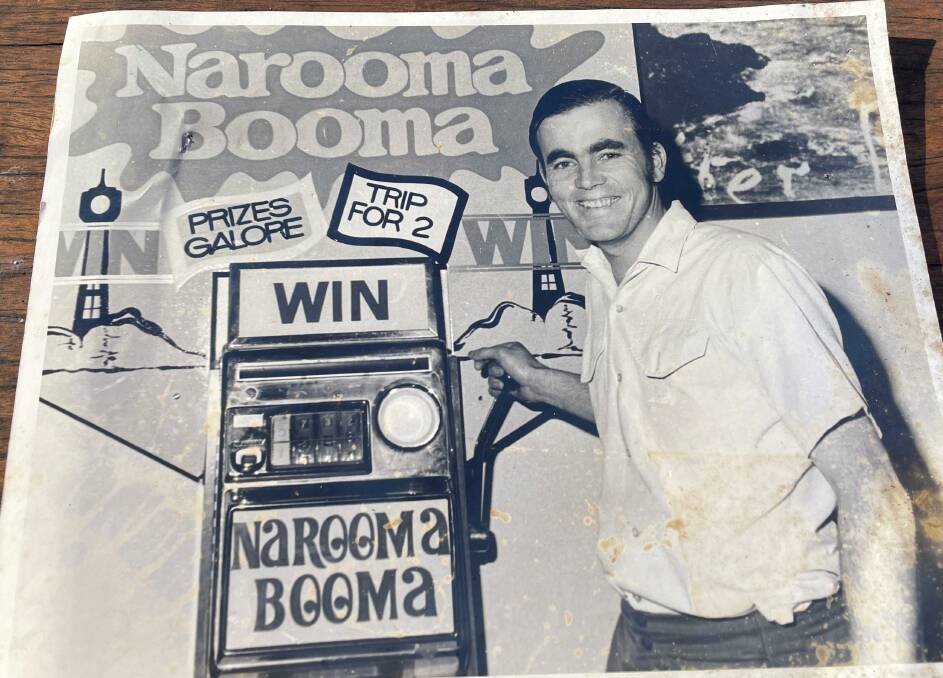 A photograph of a younger Bill Dudley running the Narooma Booma raffle to fund the running of the Visitor Information Centre. Picture by Marion Williams.