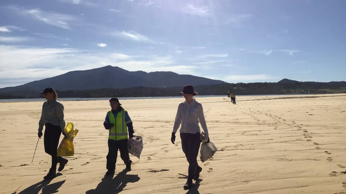 Collecting marine debris from the dunes. They brought back bottles, lids and a tyre. Photo: Luke Hamilton