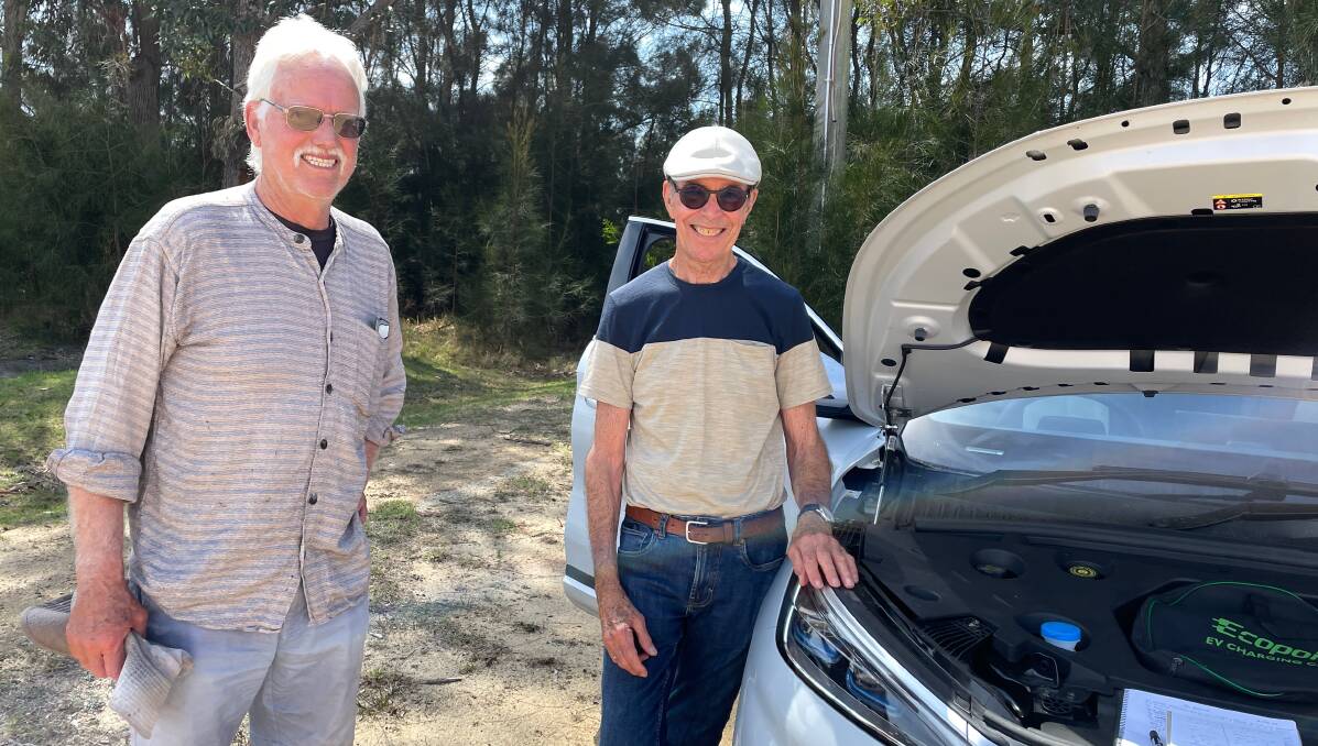 Neil Curry of Tanja (left) speaking with Tilba's Stuart Absalom about his BYD Atto 3 at Renewable Cobargo's EV Show and Tell in Bermagui on Saturday, October 21. Picture by Marion Williams