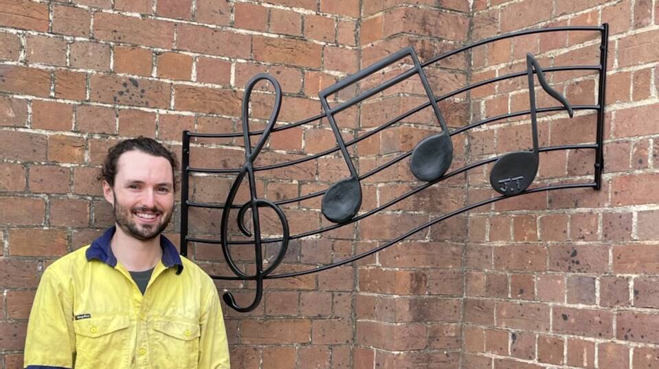 Jordan Tarlinton with a memorial sculpture at St Patrick's in Bega. Picture supplied.