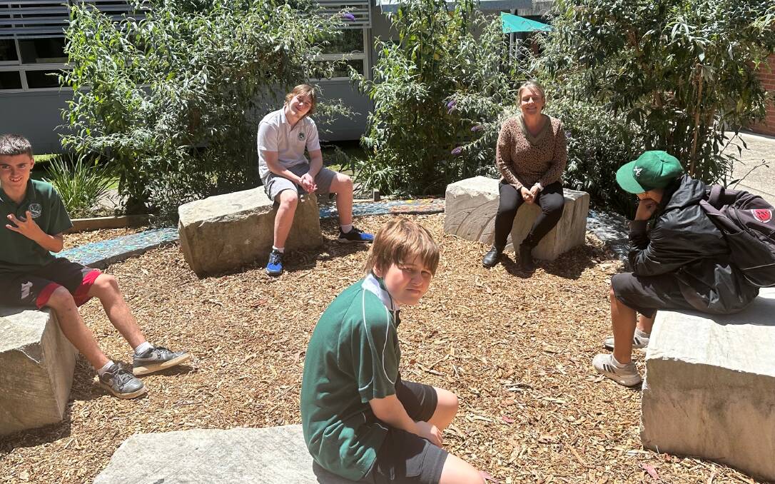 Narooma High School students Bryce (Year 9), LB (Year 10), Melanie Austin, Joseph (Year 7, with his back to the camera) and Michael (Year 7, foreground) in the new meeting place they created this year. Picture supplied