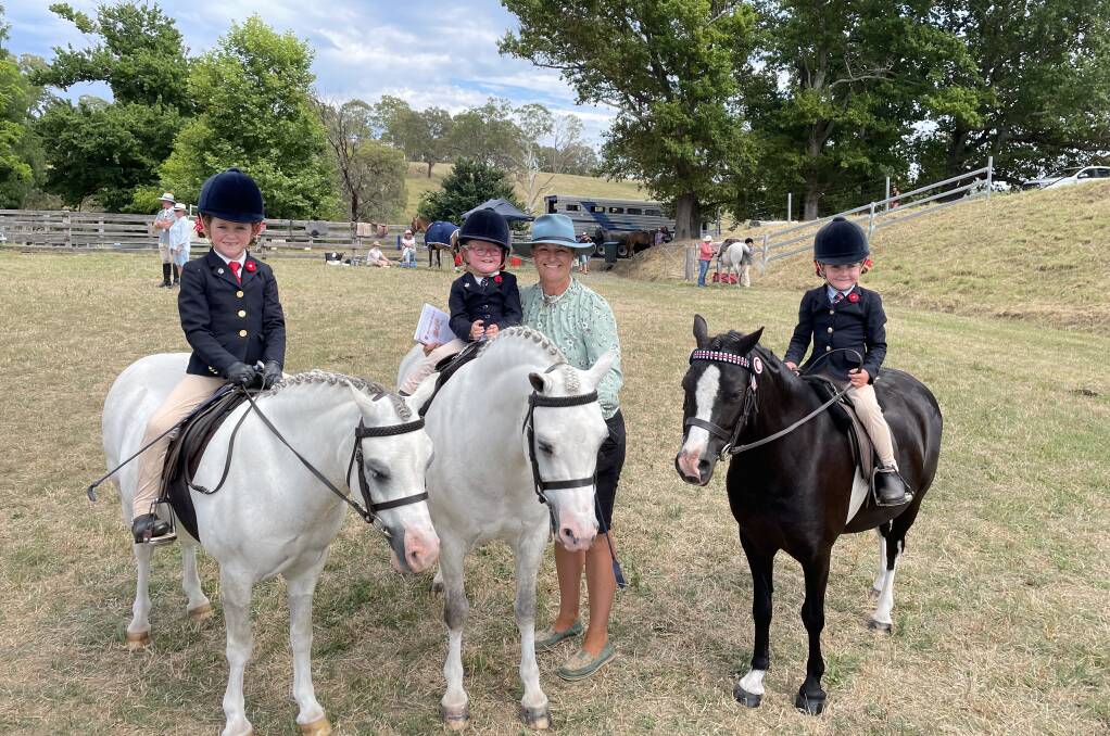 Hallie, Lexie and Lacey Cowdroy with mum Kristen Cowdroy from Cobargo on their horses Calvin, Jackson and Bubble. At six, two and four years old the Cowdroy girls will have lots of Candelo Shows to look forward to. Photo by Sam Armes. 