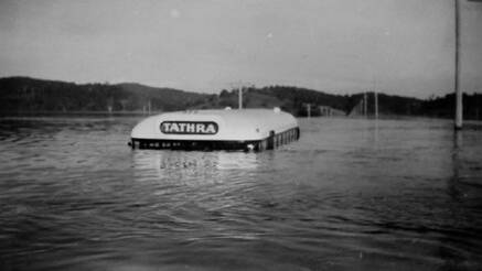 In October 1959 the Tathra bus, with three people on board, was caught in flood waters at Jellat Jelllat. The three occupants on board were able to swim to a nearby willow-tree and were rescued some hours later by heavy vehicles from the Department of Main Roads and by two outboard motor boat crews. Photo supplied. 