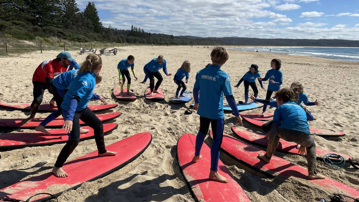 From paddling to standing up to shakkas, students embrace surfing. Picture by James Parker 