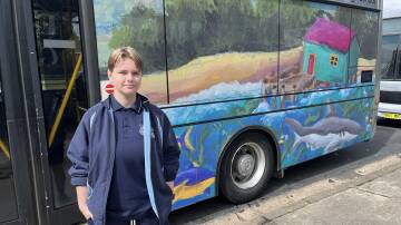 Matilda Henderson with her Mitchies Jetty impressionist art style painting turned bus vinyl wrap. Picture by James Parker
