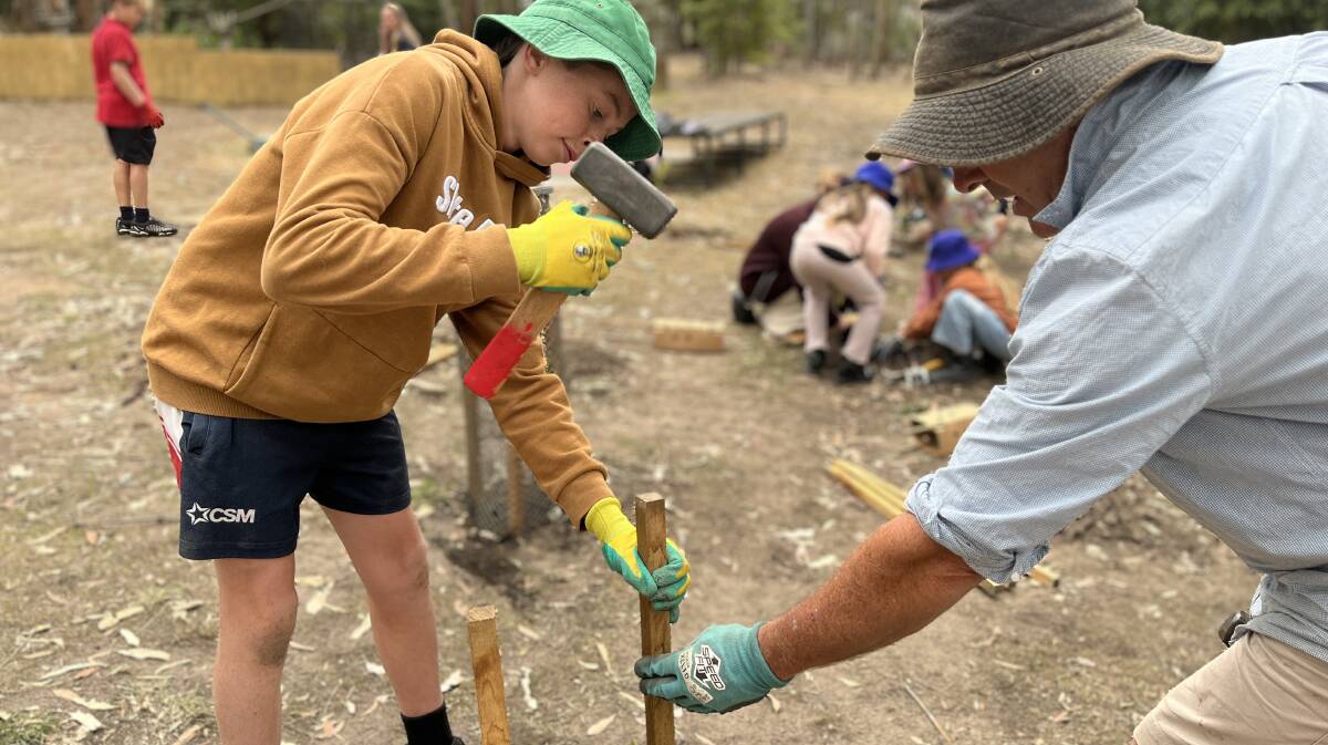 Ashton placing a stake in the ground at Potoroo Palace. Picture by James Parker