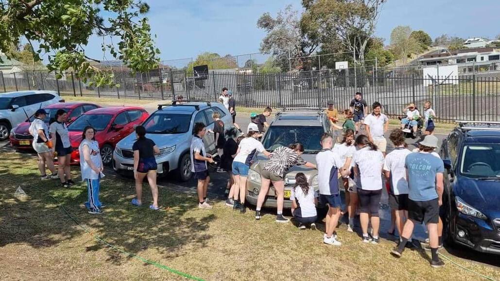 Year 12 Bega High School students wash teachers' cars to raise money for formal activities. Picture supplied