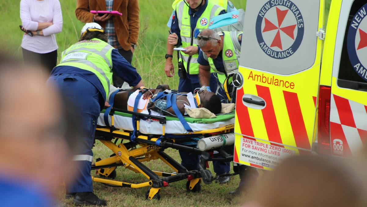 NSW Ambulance paramedics attend to the 'injured bike rider.' Picture by James Parker