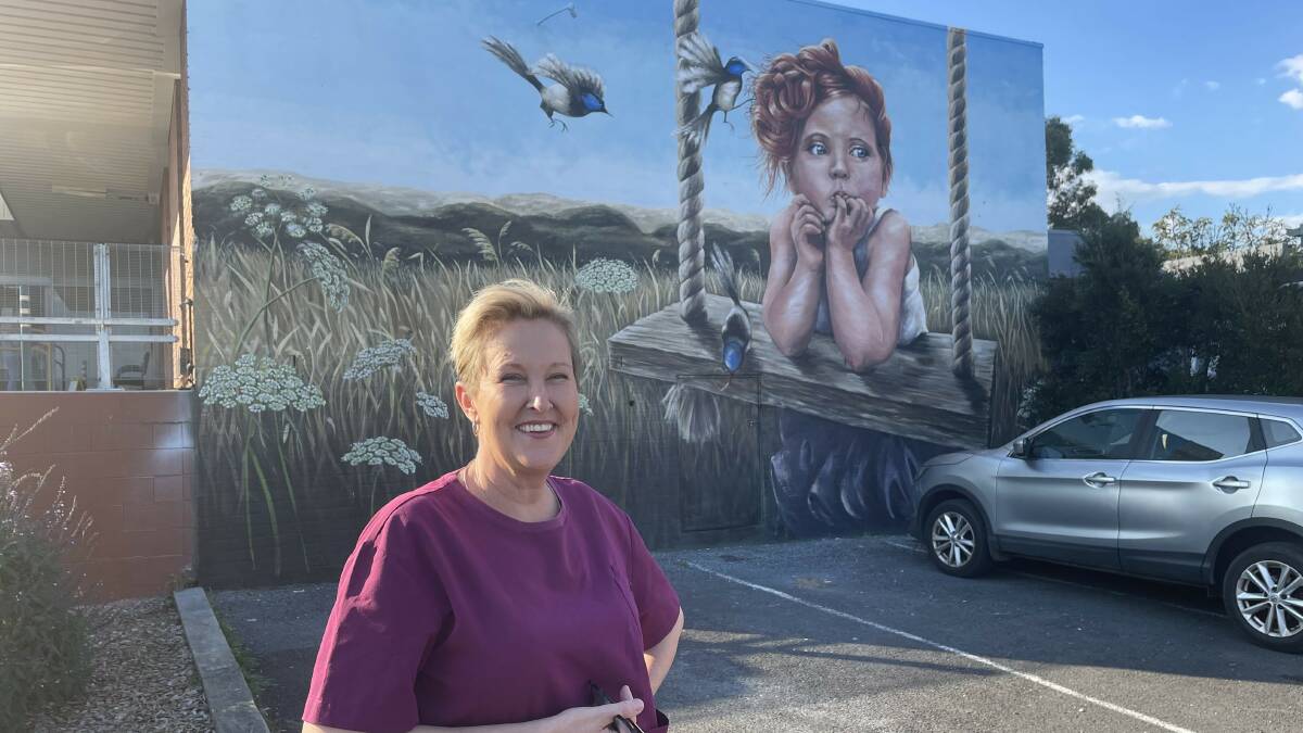 Terri Tuckwell stands in front of her mural in Pambula. Picture by James Parker