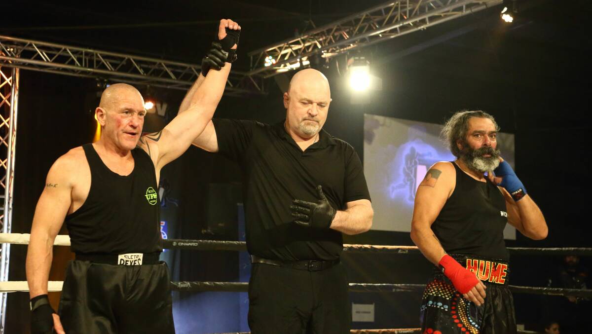 Darrell Parker's hand is raised having won the Interstate Challenger Title Belt. Picture by Oscar Munro Photography.