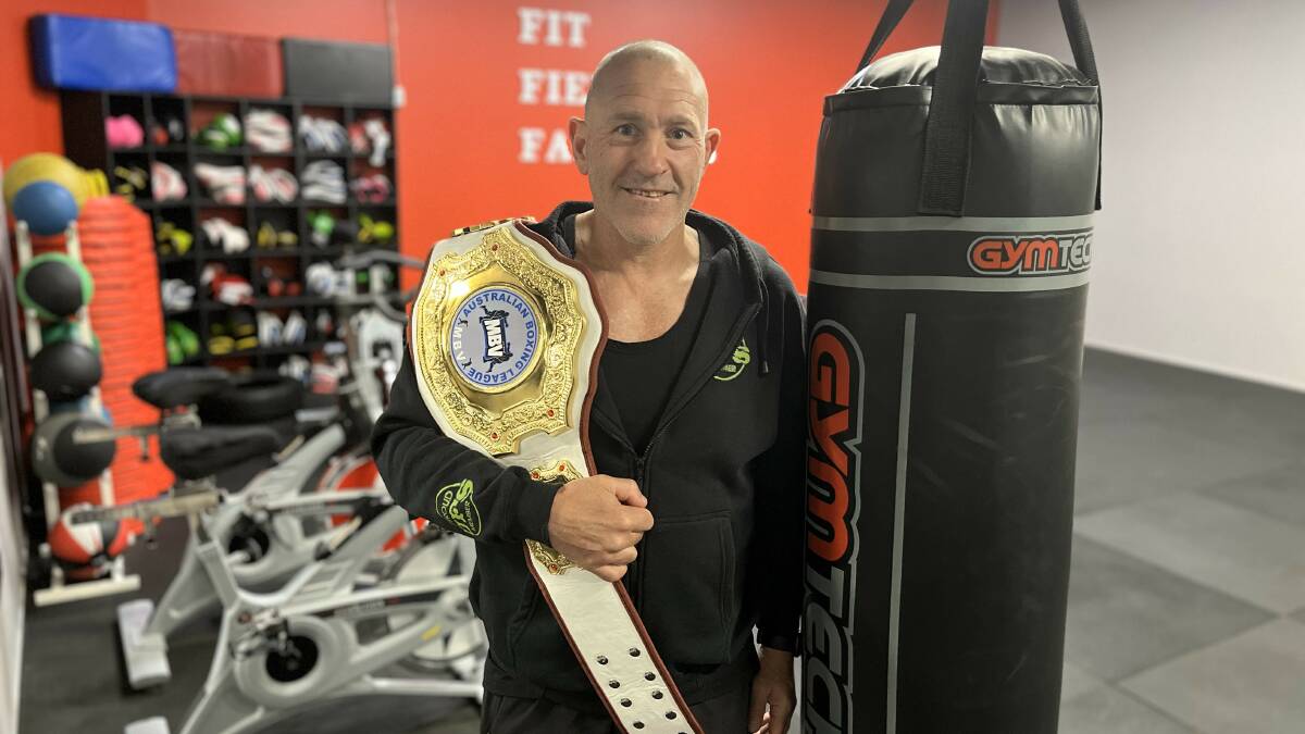 Darrell Parker in his element at United Fitness Studio in Bega, his title belt proudly over his shoulder. Picture by James Parker
