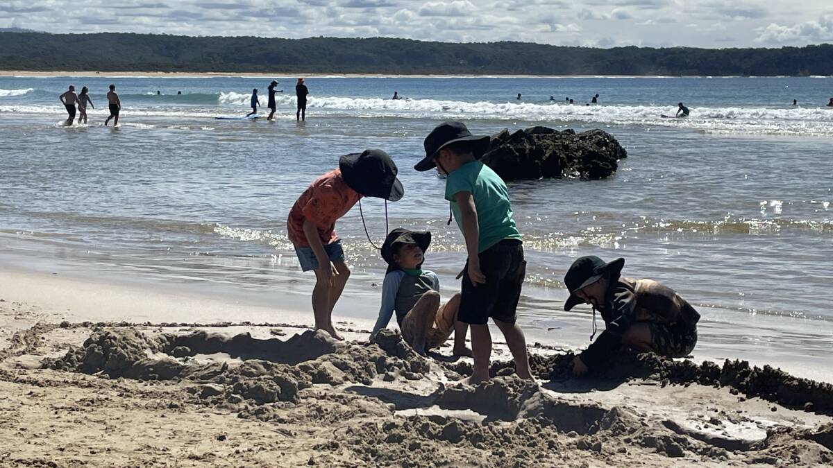 Digging, building, jumping and watching the water in the sand. Picture by James Parker 