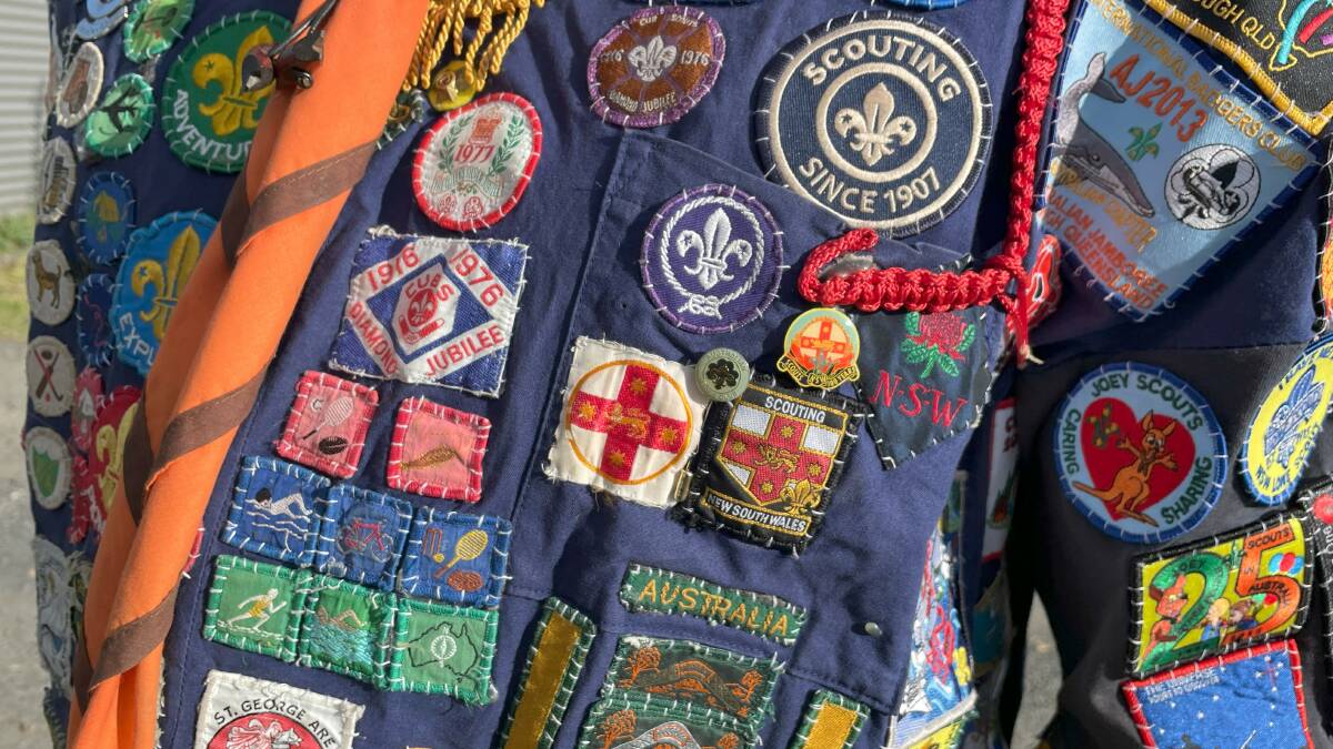 Stitched across his uniform, an array of colourful patches show previous camps this leader has participated on. Picture by James Parker
