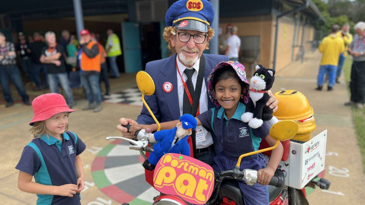 Postman Pat and two young girls from Merimbula Public School. Picture by James Parker