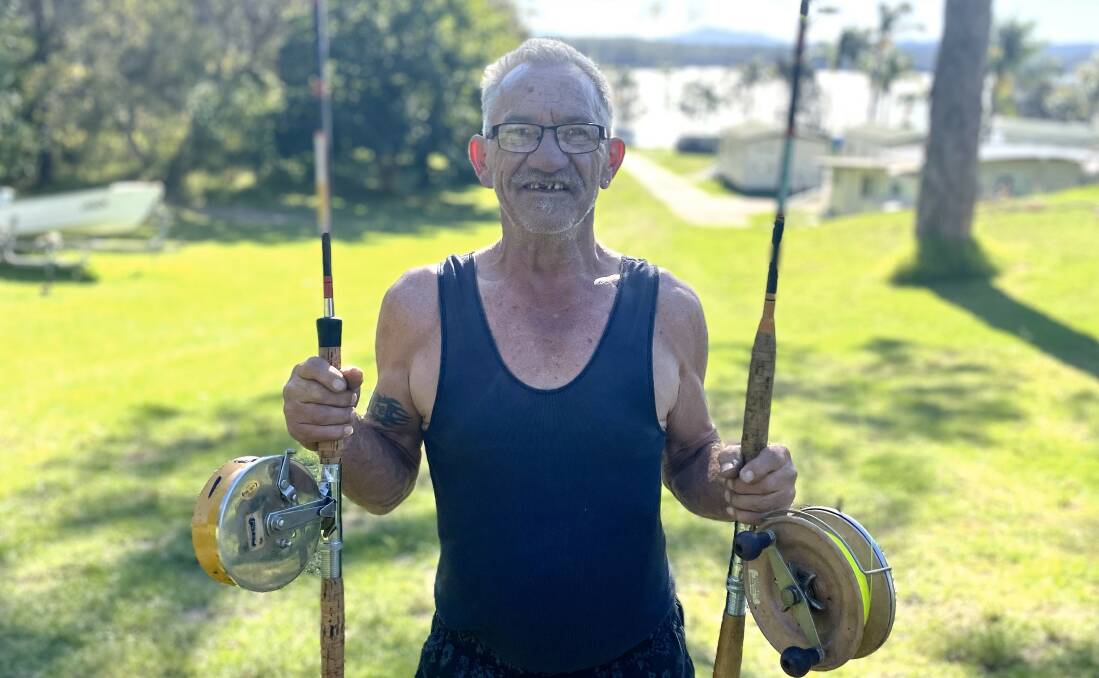 Andy Huk, aka Bermi Wharf Rat, smiles with two of his vintage fishing rods and reels. Picture by James Parker 