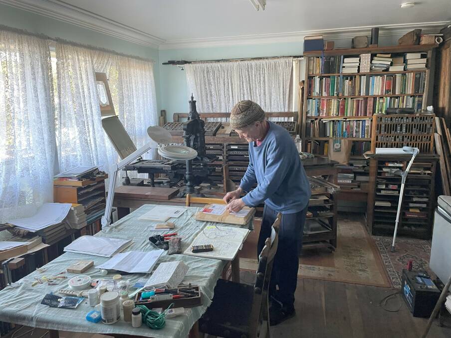 The printing master within his living room, covered with cases, book shelves, and the history of printing. Picture by James Parker.