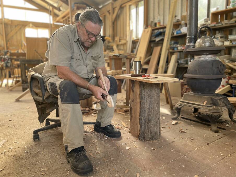 Paul 'Polly' Boyer carving in his custom built shed. Picture by James Parker