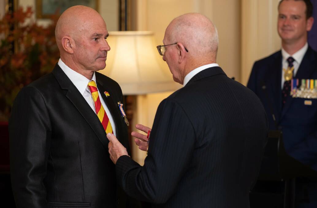 HONOURED: Tony Rettke is presented with his Emergency Services Medal by Governor General David Hurley at Government House Canberra. Photos: Australian Honours and Awards Secretariat