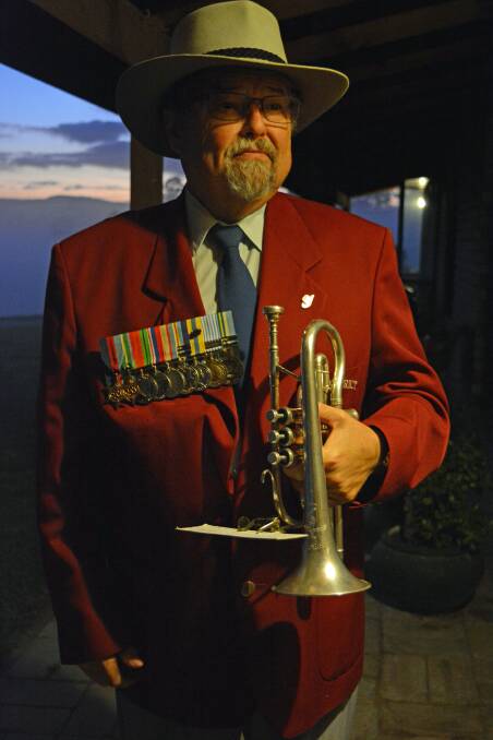 John Winson plays Last Post and Reveille from his front verandah looking out over Bega on Anzac Day 2020. Photo: Ben Smyth