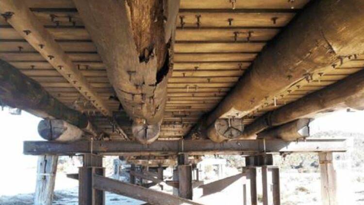 The timber supports underneath Cuttagee Bridge are in poor order, triggering discussions over its replacement.