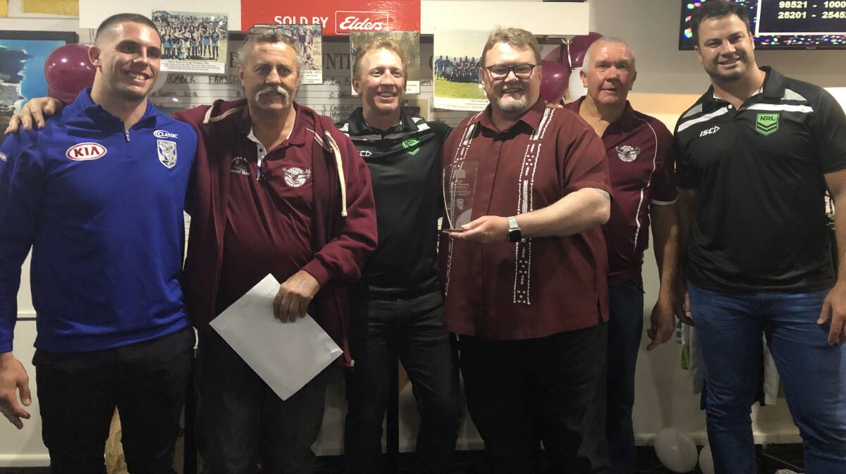 NRL players Adam Elliott, Alan Tongue and David Shillington present the 2019 Grassroots Club of the Year to Tathra Rugby League Football Club.