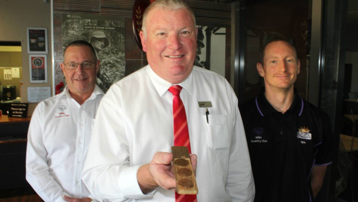 Bega's "boxer" Simon Owens prepares for the annual two-up festivities at Club Bega following the 2018 service with club general manager Dave Mitchell and Kyle Bourke.