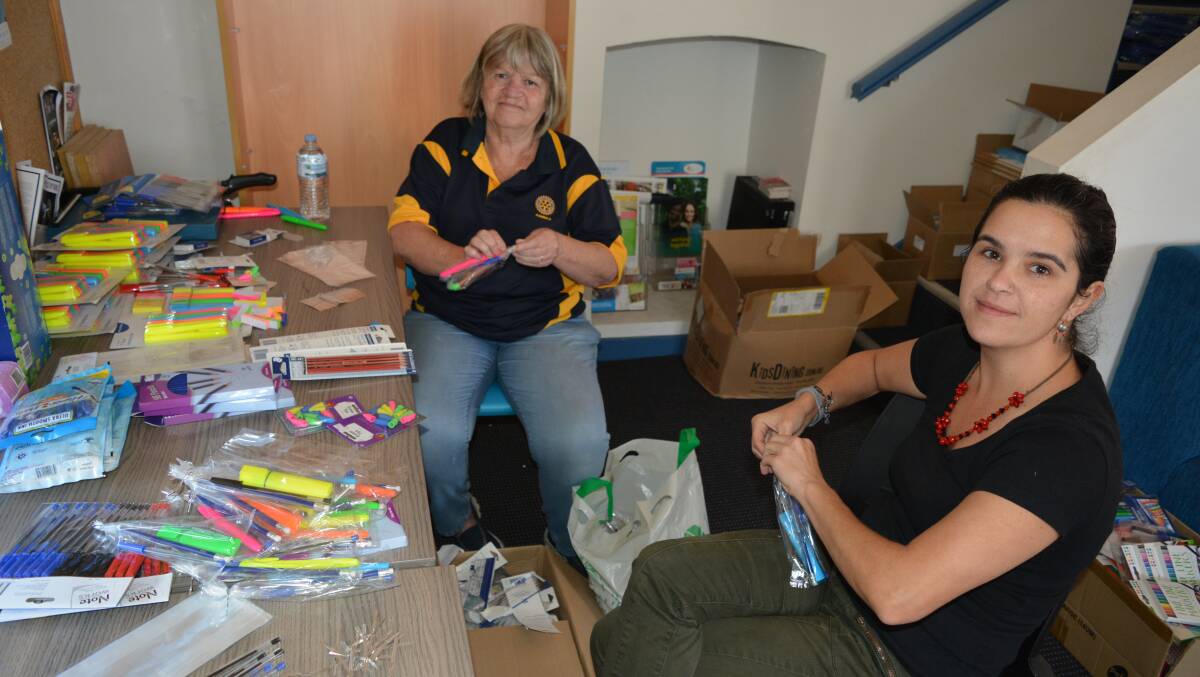 Beth Moore from Pambula Rotary and PCYC volunteer Mariana Maldini help pack donations of stationery into the activity bags.