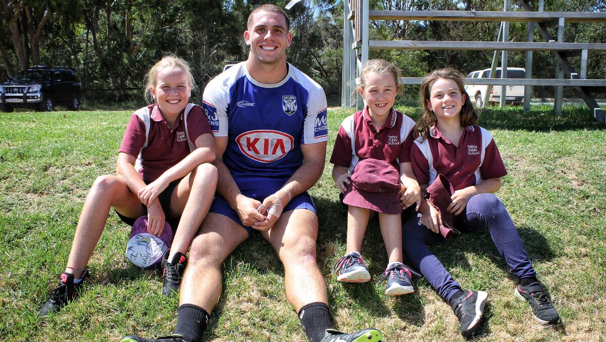 HOME: Junior Sea Eagles players Mali Whatmore, Eloise Wallace and Ruby Blankenstein with Adam Elliott during his visit in February 2019. Photo: Alasdair McDonald