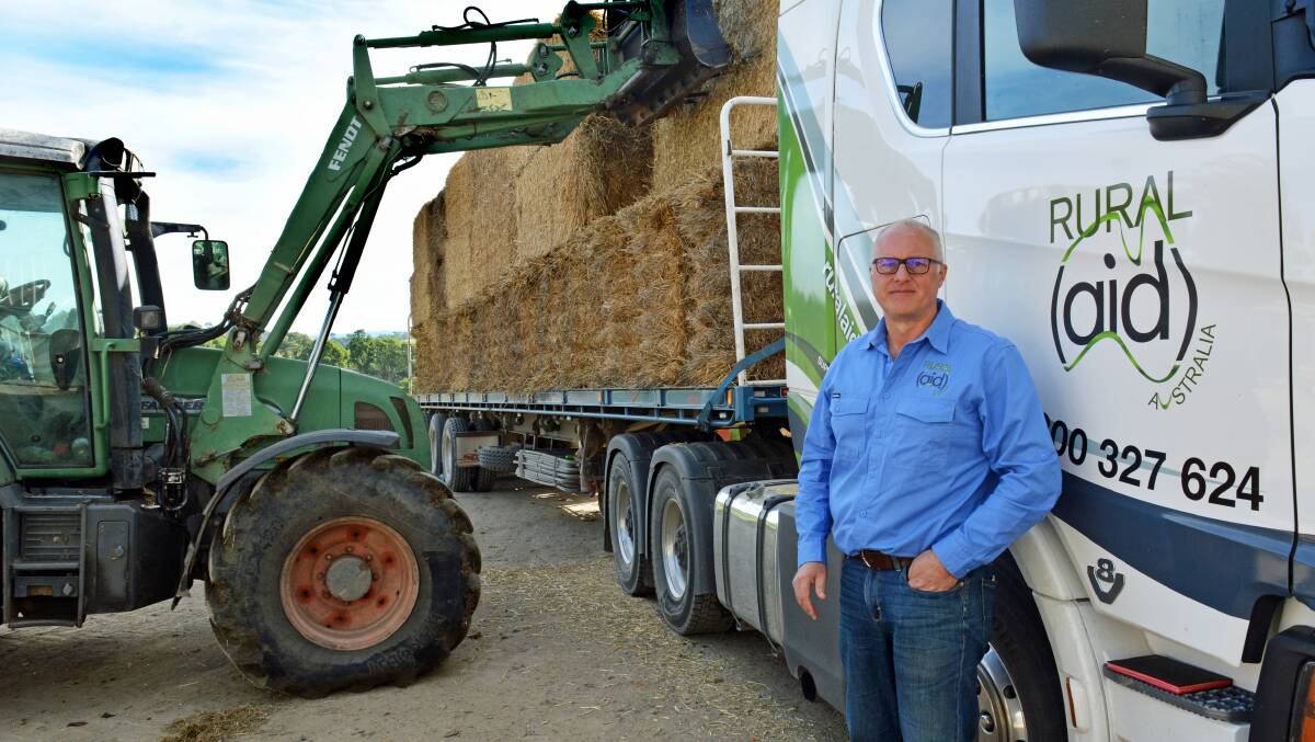FEEDING THE MASSES: Rural Aid business development manager Craig Marsh supervises the delivery of 52 tonnes of hay for farmers in the Bega district on Tuesday. Photo: Ben Smyth