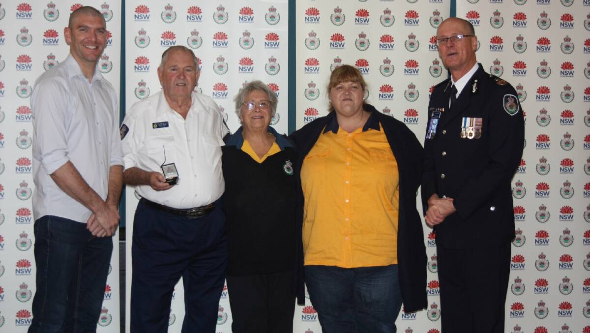 RFS Deputy Commissioner Kyle Stewart APM and Eurobodalla Shire Mayor Matthew Hatcher present Bruce Smith his 60 year Long Service Clasp alongside his wife, Barb and daughter, Kerrie.