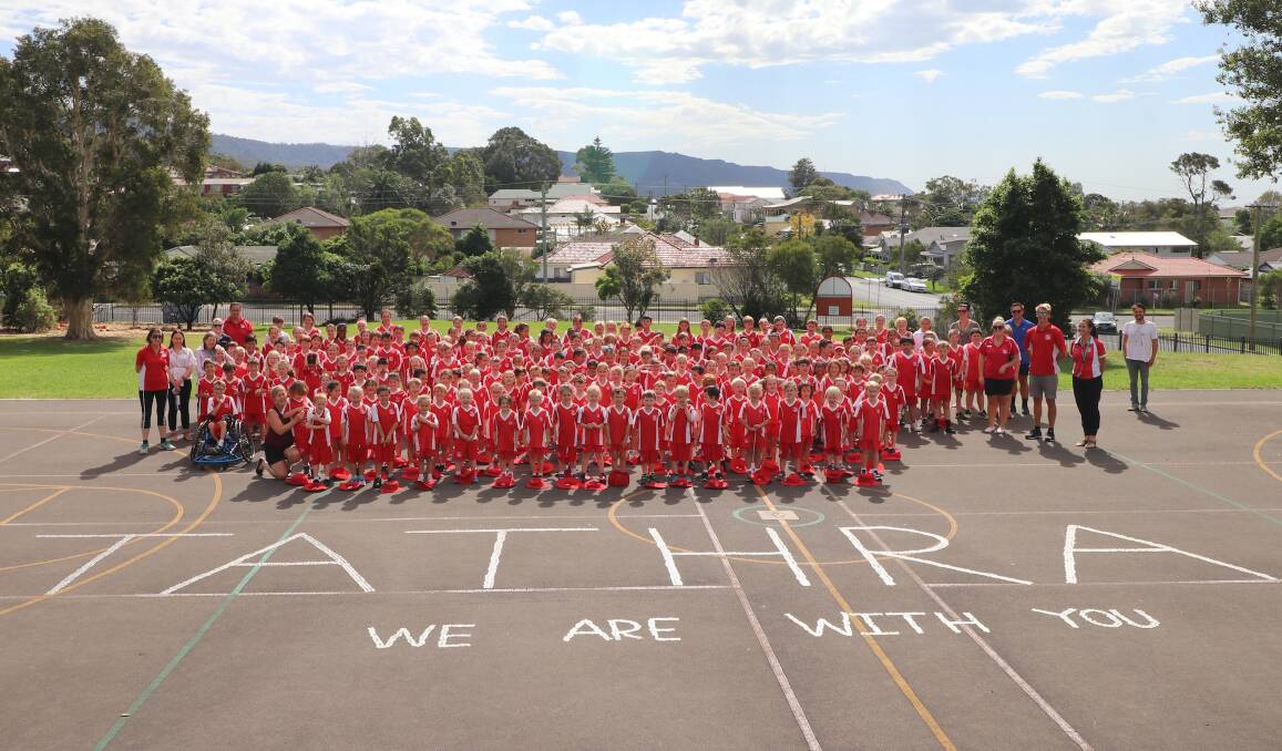 WE ARE WITH YOU: Pupils at Corrimal Public School spell out a message of solidarity for Tathra with donated coins destined for the bushfire appeal.