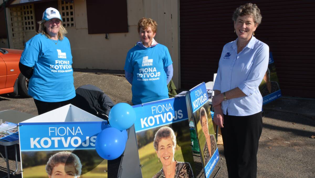 Liberal candidate Fiona Kotvojs chats with her polling booth volunteers Carol Carmody and Robyn Darke in Bega on Monday. Photo: Ben Smyth